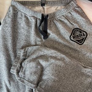 Muskoka bear wear grey sweat pants paw prints